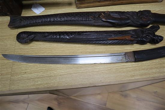 Two 19th century Japanese swords the wood scabbards, carved as a dragon and a merman longest 67cm